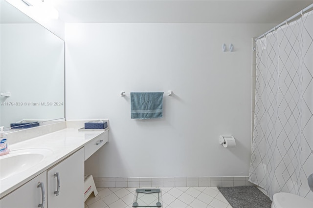 bathroom featuring tile patterned flooring, vanity, and toilet