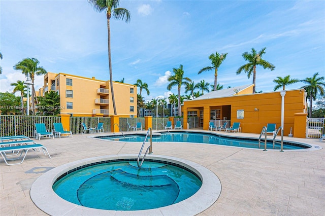 view of swimming pool with a patio area and a community hot tub