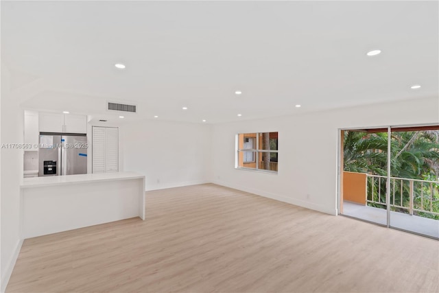 unfurnished living room featuring light hardwood / wood-style floors