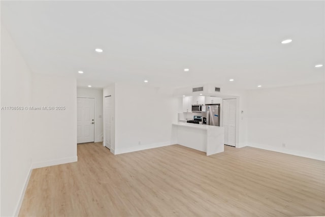 unfurnished living room with light hardwood / wood-style floors