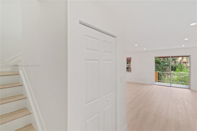 hallway with light hardwood / wood-style flooring