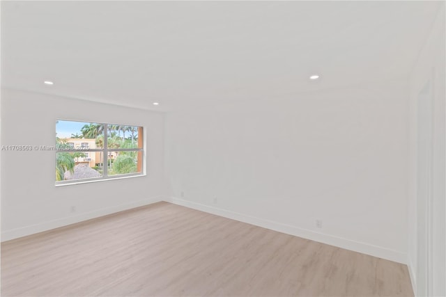 spare room with light hardwood / wood-style floors