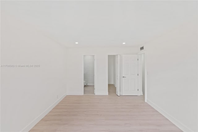 spare room featuring light wood-type flooring