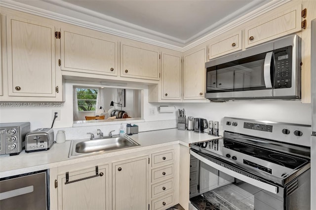 kitchen with light brown cabinetry, sink, and appliances with stainless steel finishes