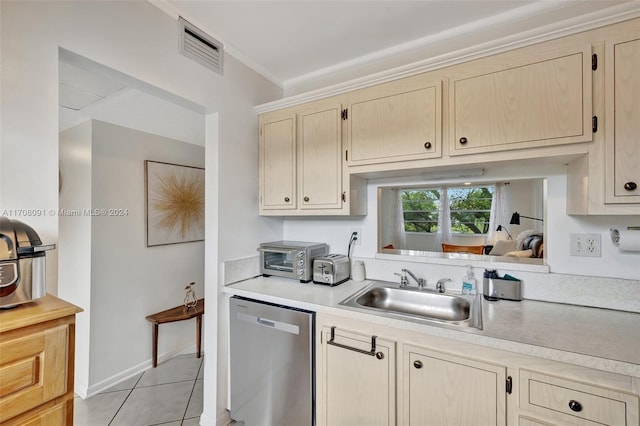 kitchen with dishwasher, light brown cabinets, sink, light tile patterned floors, and ornamental molding