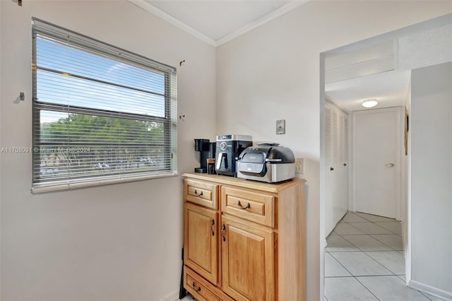 kitchen with light tile patterned floors and ornamental molding