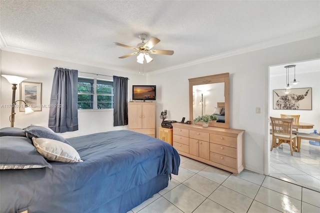 tiled bedroom with a textured ceiling, ceiling fan, and crown molding