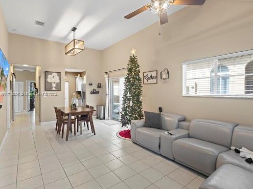 tiled living room featuring ceiling fan