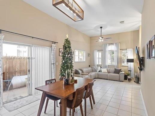 dining area featuring light tile patterned floors and ceiling fan