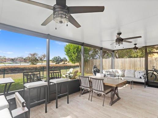 sunroom with plenty of natural light and ceiling fan