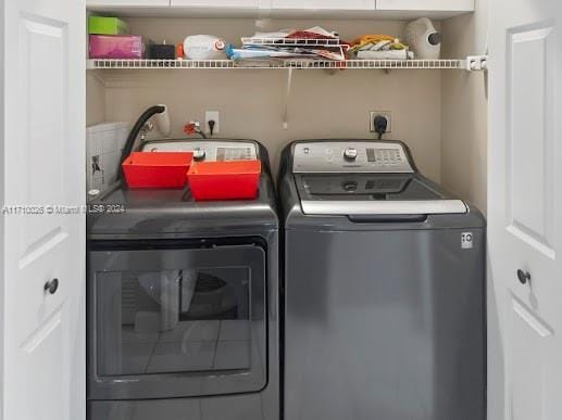 clothes washing area with separate washer and dryer