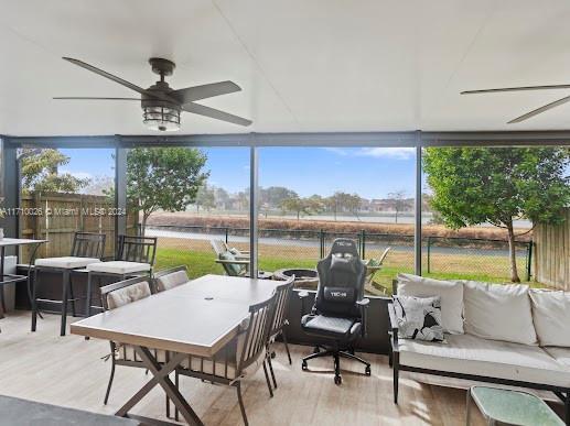 sunroom / solarium featuring ceiling fan