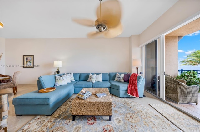 living room featuring ceiling fan and a healthy amount of sunlight