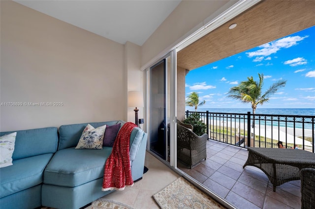 balcony featuring a water view and a view of the beach