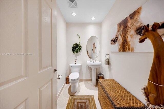 bathroom featuring tile patterned flooring, sink, and toilet