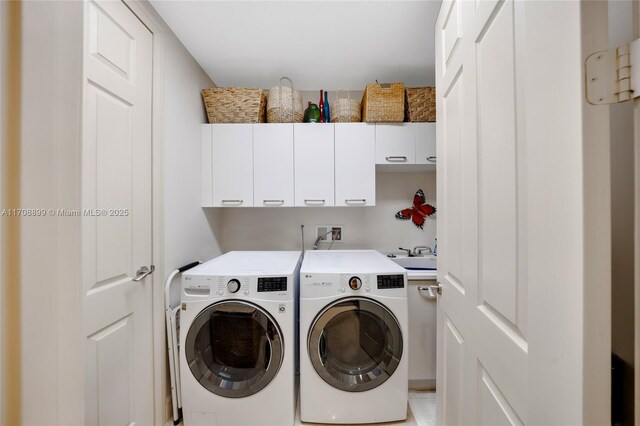 laundry room featuring sink, cabinets, and washing machine and clothes dryer