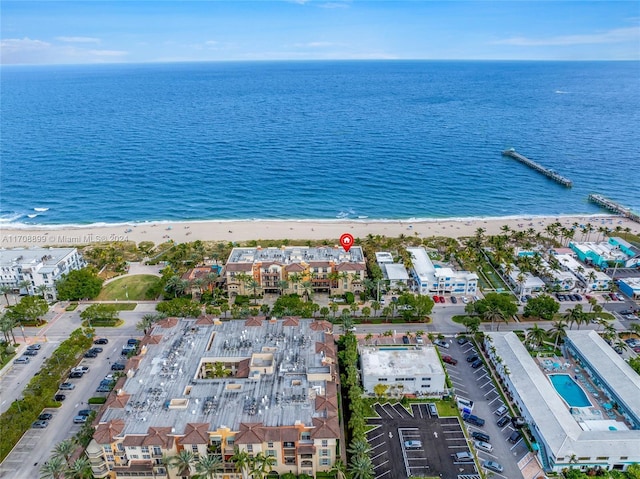 drone / aerial view with a beach view and a water view