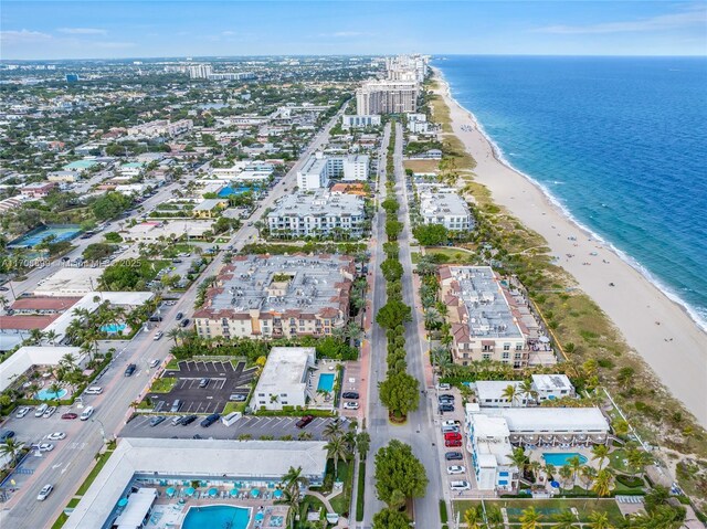 aerial view with a water view and a beach view