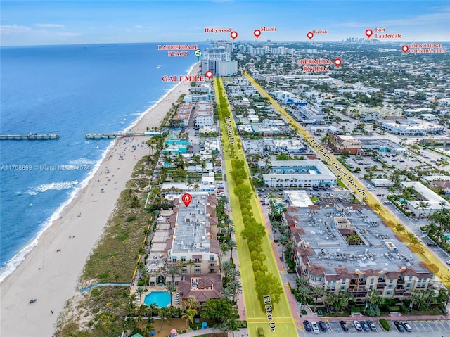 drone / aerial view featuring a beach view and a water view