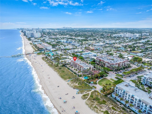 drone / aerial view with a beach view and a water view