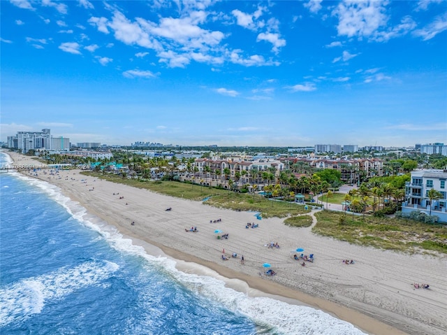 bird's eye view with a water view and a beach view