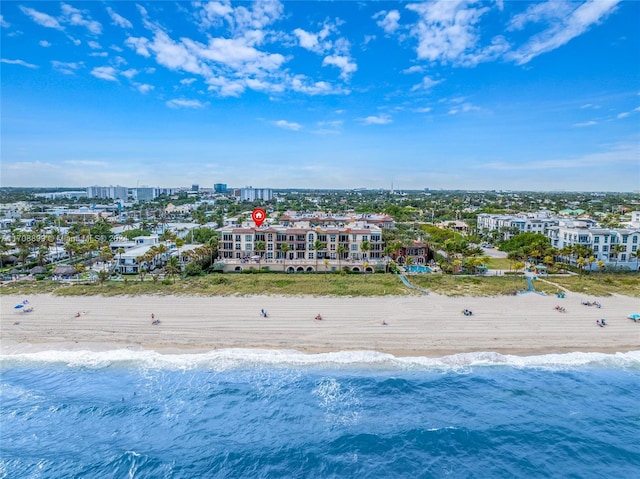 drone / aerial view featuring a beach view and a water view