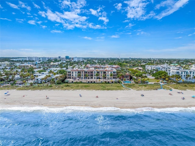 drone / aerial view featuring a water view and a view of the beach