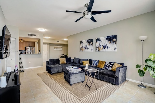 living room featuring ceiling fan and light tile patterned flooring