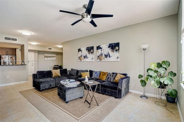 tiled living room with ceiling fan