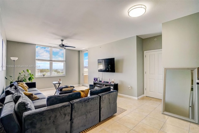 living room with ceiling fan and light tile patterned floors