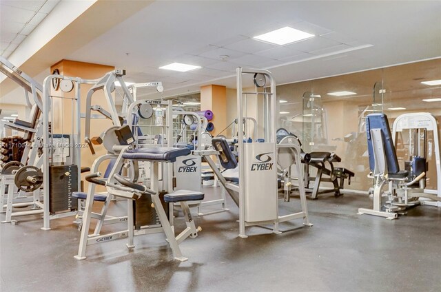 exercise room with a paneled ceiling