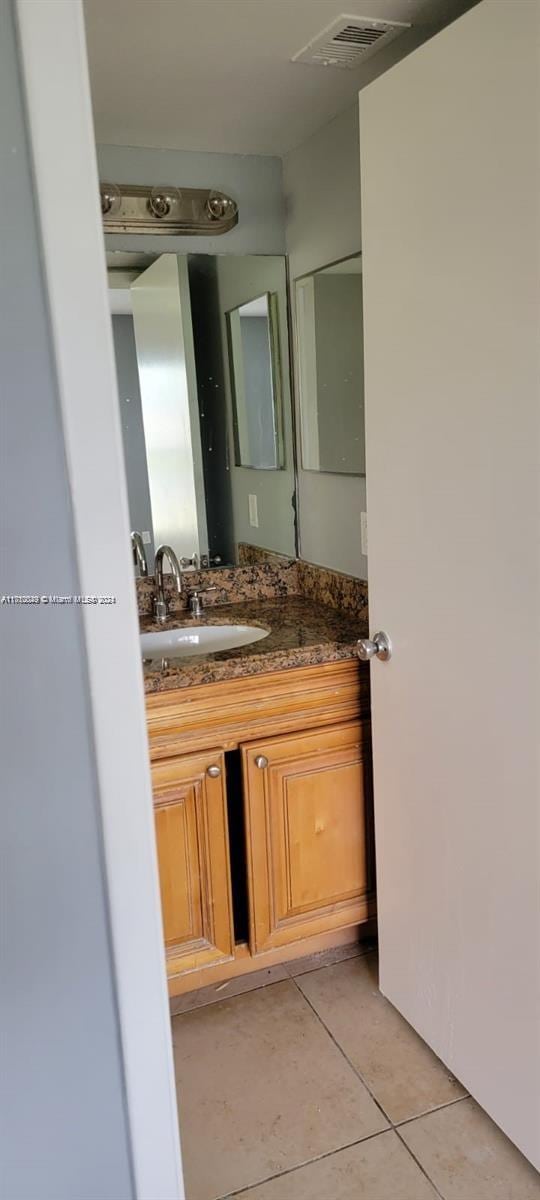 bathroom featuring tile patterned flooring and vanity