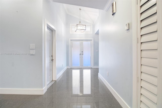 corridor featuring a chandelier, high vaulted ceiling, and french doors