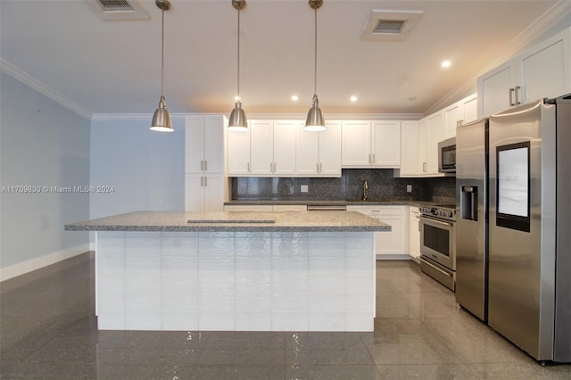 kitchen featuring white cabinets, appliances with stainless steel finishes, a kitchen island, and pendant lighting