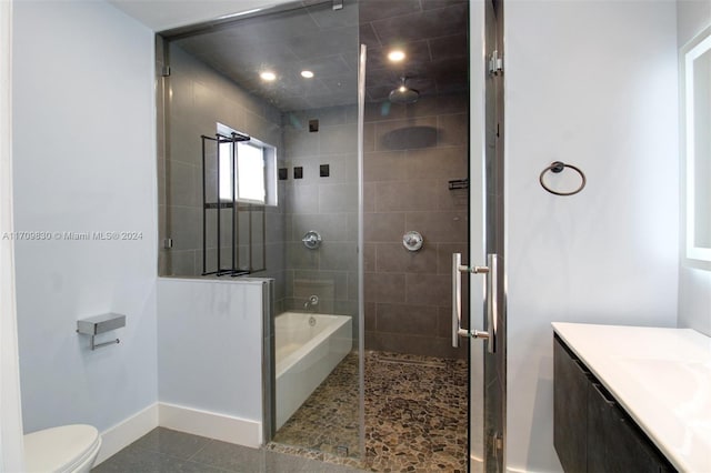 bathroom with tile patterned flooring, vanity, a shower with shower door, and toilet