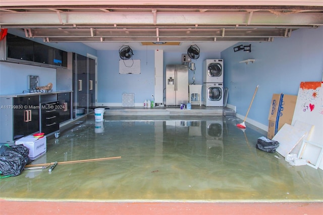 garage with stacked washer and clothes dryer