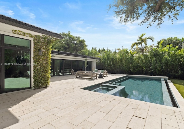 view of pool with an in ground hot tub, an outdoor living space, and a patio