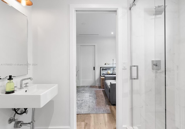 bathroom featuring hardwood / wood-style floors, sink, and walk in shower