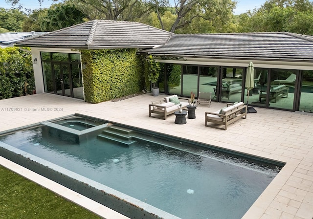 view of pool featuring a patio area, an in ground hot tub, and an outdoor hangout area