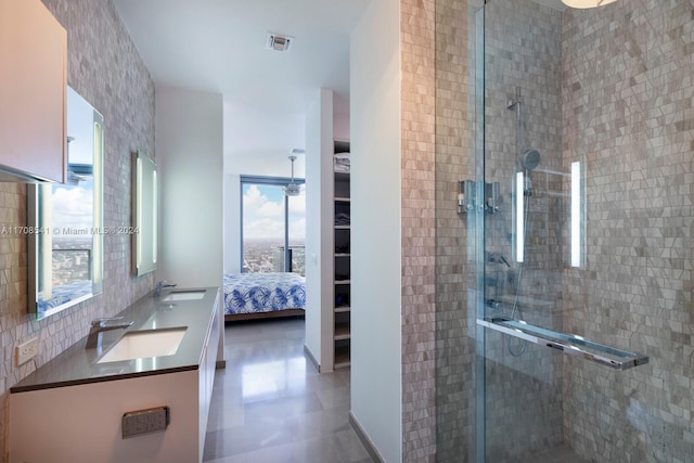 bathroom featuring vanity, tile patterned floors, and walk in shower