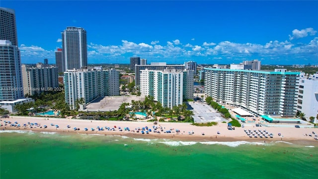 drone / aerial view featuring a view of the beach and a water view