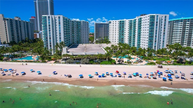 aerial view with a water view and a beach view