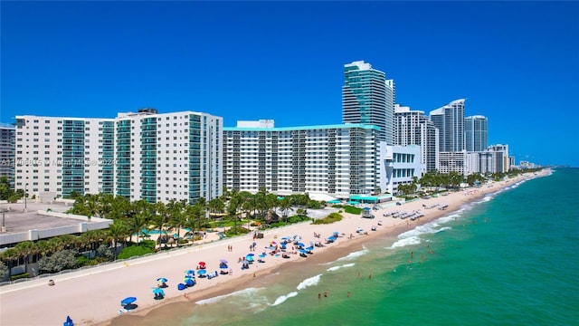 bird's eye view featuring a water view and a beach view