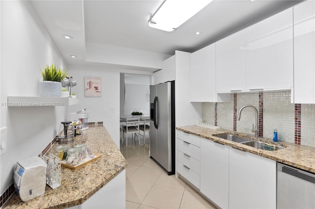 3901 S Ocean Dr Unit 15N, Hollywood, FL 33019 - kitchen featuring stainless steel appliances, decorative backsplash, white cabinets, light tile patterned floors, and modern cabinets
