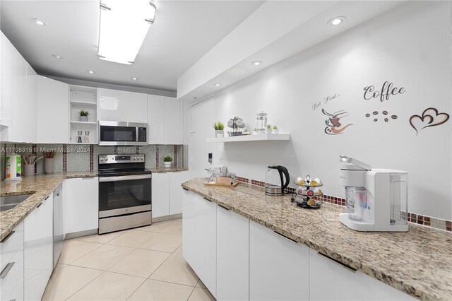 3901 S Ocean Dr Unit 15N, Hollywood, FL 33019 - kitchen with open shelves, appliances with stainless steel finishes, decorative backsplash, white cabinetry, and recessed lighting