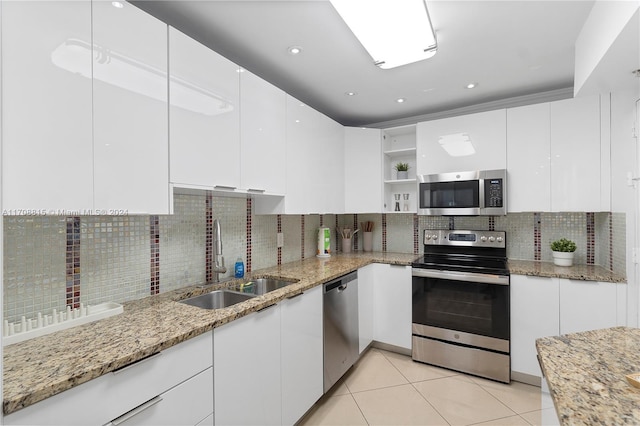 kitchen featuring white cabinets, light stone counters, sink, and stainless steel appliances