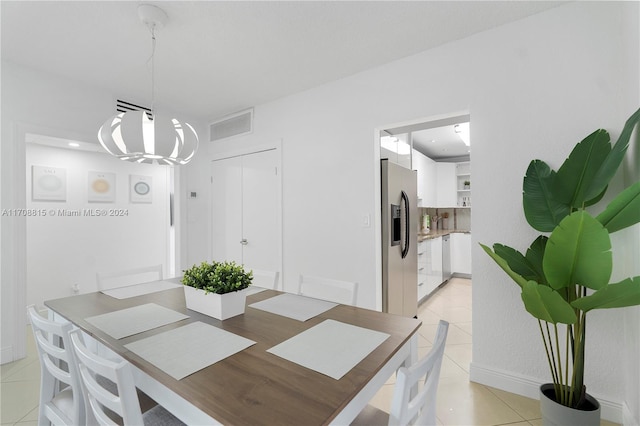 3901 S Ocean Dr Unit 15N, Hollywood, FL 33019 - dining room featuring light tile patterned floors and a chandelier
