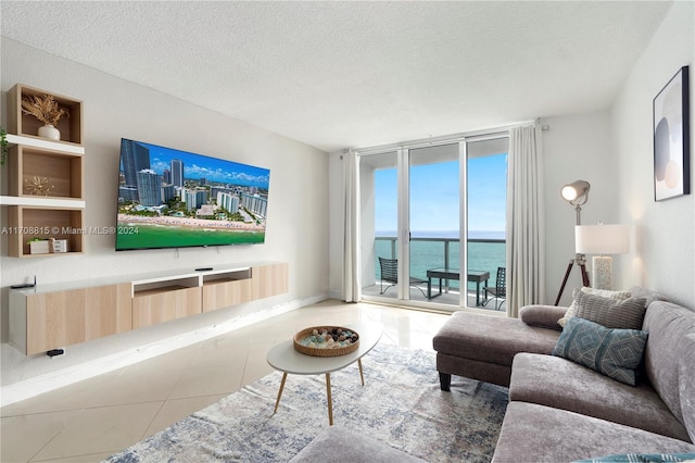 tiled living room with a wall of windows and a textured ceiling