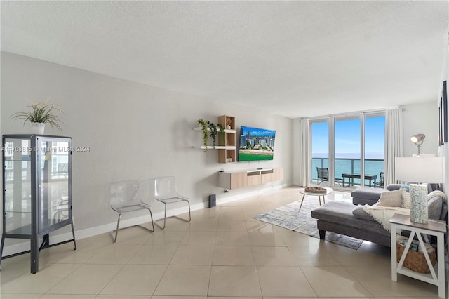 3901 S Ocean Dr Unit 15N, Hollywood, FL 33019 - living area with a textured ceiling, a wall of windows, and tile patterned flooring