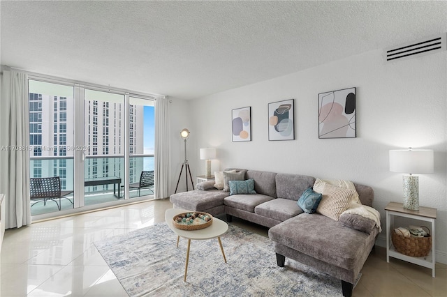 living room featuring light tile patterned floors and a textured ceiling